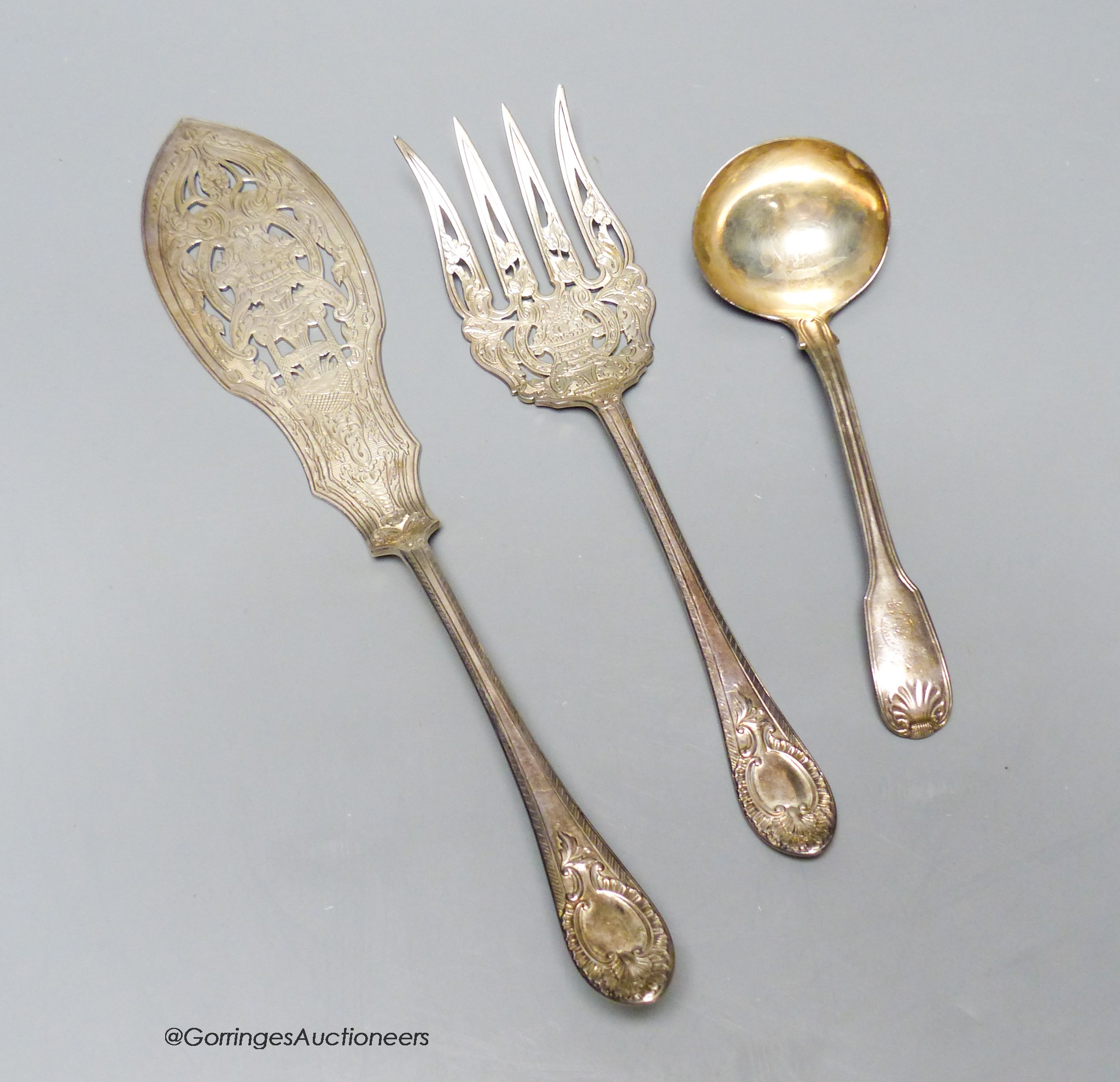 A pair of Victorian engraved silver fish servers, Sheffield, 1868 and a George III silver fiddle and thread pattern sauce ladle, London, 1820, 12.5oz.